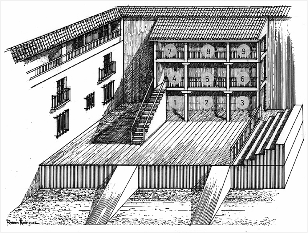 An open-air, wooden platform stage is framed at the back by a three-tiered structure—and to the left by a whitewashed exterior wall with windows.